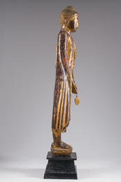 A tall Thai inlaid gilt lacquered wooden figure of a standing Buddha, 19th/20th C.