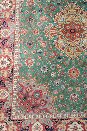 A Persian Tabriz rug with floral design, wool on cotton, first half 20th C.