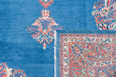 A Persian Sarouk rug with central medallion and floral design, wool on cotton, 20th C.