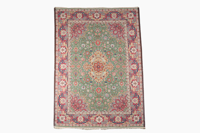 A Persian Tabriz rug with floral design, wool on cotton, first half 20th C.
