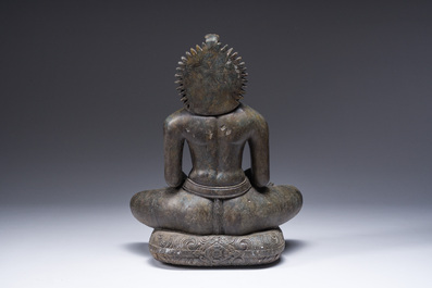 An Indian polished black marble sculpture of a Jina seated in dhyanasana on an ornate cushion, probably Gujarat, 15th C.