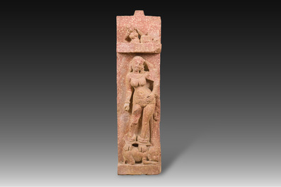A large Indian red sandstone stupa pillar with a devata shown as a woman and lotus flowers, probably Matura region, ca. 2nd C. b.C - 2nd C.