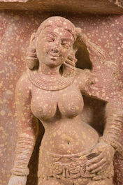 A large Indian red sandstone stupa pillar with a devata shown as a woman and lotus flowers, probably Matura region, ca. 2nd C. b.C - 2nd C.