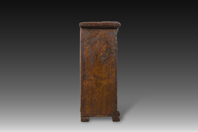 A carved oak one-door cupboard with the central panel carved with two heads, probably Germany, 16th C.