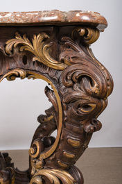 An impressive parcel-gilt and patinated wooden console in Rococo style, probably Italy, 19th C.