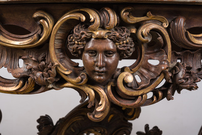 An impressive parcel-gilt and patinated wooden console in Rococo style, probably Italy, 19th C.