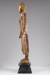 A tall Thai inlaid gilt lacquered wooden figure of a standing Buddha, 19th/20th C.