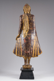 A tall Thai inlaid gilt lacquered wooden figure of a standing Buddha, 19th/20th C.