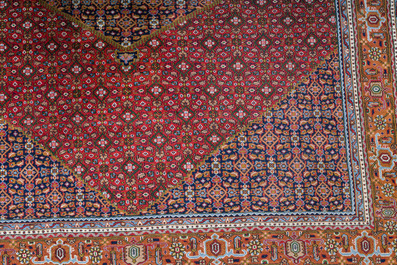 A Persian Bidjar rug with floral design, wool on cotton, 20th C.