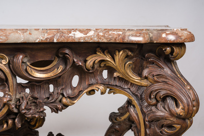 An impressive parcel-gilt and patinated wooden console in Rococo style, probably Italy, 19th C.
