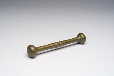 Two bells, a mortar and stamper, three candlesticks and an alms dish in bronze and brass, 17th/19th C.