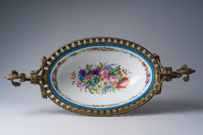 A large French S&egrave;vres style gold layered 'bleu c&eacute;leste' ground porcelain gilt bronze mounted oval bowl with floral design and putti, 19th/20th C.