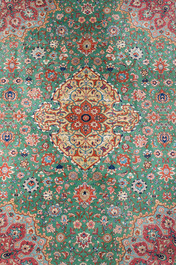 A Persian Tabriz rug with floral design, wool on cotton, first half 20th C.
