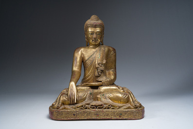 A tall Thai inlaid partly gilt lacquered wooden figure of a seated Buddha, 19th/20th C.