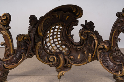 An impressive parcel-gilt and patinated wooden console in Rococo style, probably Italy, 19th C.