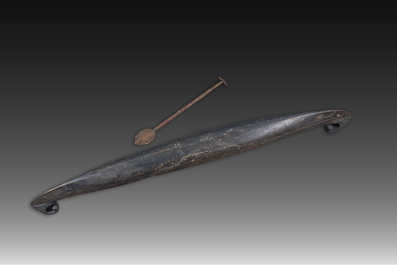 A large Indian wooden Kerala snake canoe with a curled stem and stern with accompanying paddle, 20th C.