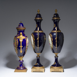 Three French gold layered blue ground gilt bronze mounted S&egrave;vres style vases and covers with gallant scenes, 20th C.
