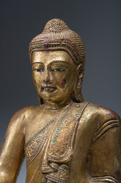 A tall Thai inlaid partly gilt lacquered wooden figure of a seated Buddha, 19th/20th C.