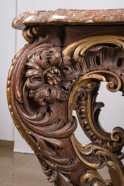 An impressive parcel-gilt and patinated wooden console in Rococo style, probably Italy, 19th C.
