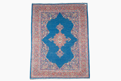 A Persian Sarouk rug with central medallion and floral design, wool on cotton, 20th C.