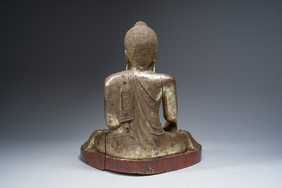 A tall Thai inlaid partly gilt lacquered wooden figure of a seated Buddha, 19th/20th C.