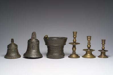Two bells, a mortar and stamper, three candlesticks and an alms dish in bronze and brass, 17th/19th C.