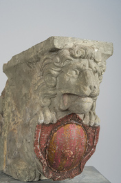 A pair of partly polychromed stone beam supports in the shape of lions holding coats of arms, probably Flanders, 16th/17th C.