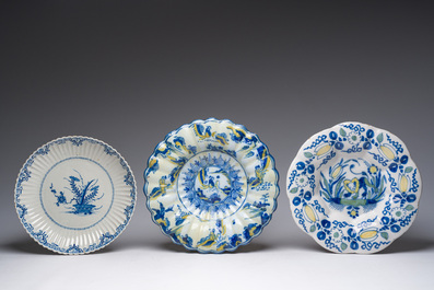 Five blue, white and polychrome Dutch Delft dishes, a lamp-mounted vase and a Brussels faience tobacco jar, 17th/19th C.