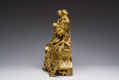 A French gilt bronze mantel clock crowned by a couple in love chatting on a bench, 19th C.