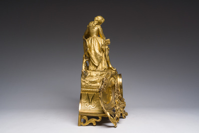 A French gilt bronze mantel clock crowned by a couple in love chatting on a bench, 19th C.