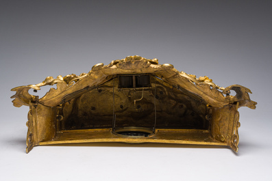 A French gilt bronze mantel clock crowned by a couple in love chatting on a bench, 19th C.