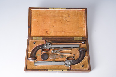 A French dueling box containing a pair of percussion pistols with damask barrels and engraved breechblocks, 19th C.