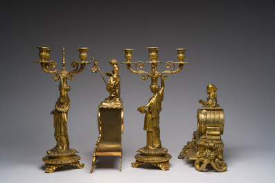 Two gilt bronze mantel clocks and a pair of four-light caryatid-shaped candlesticks, France and Germany, 19th/20th C.