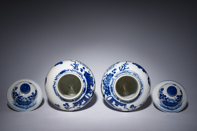 A pair of Chinese blue and white vases and covers with magpies among peonies, 19th C.
