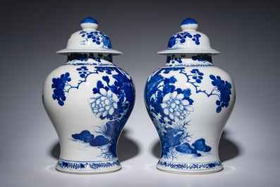 A pair of Chinese blue and white vases and covers with magpies among peonies, 19th C.