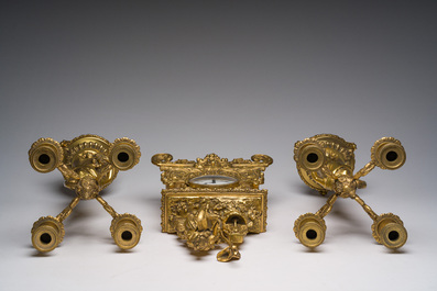 Two gilt bronze mantel clocks and a pair of four-light caryatid-shaped candlesticks, France and Germany, 19th/20th C.