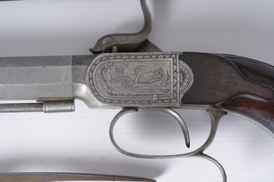 A French dueling box containing a pair of percussion pistols with damask barrels and engraved breechblocks, 19th C.