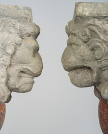 A pair of partly polychromed stone beam supports in the shape of lions holding coats of arms, probably Flanders, 16th/17th C.
