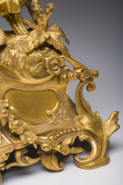 A French gilt bronze mantel clock crowned by a couple in love chatting on a bench, 19th C.