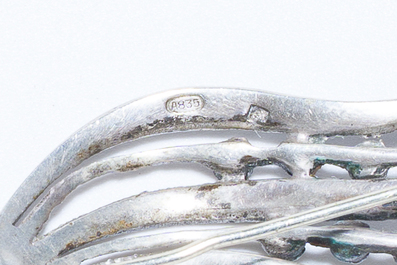 A varied collection of jewelry, including silver brooches and an 18 carat gold ring, 20th C.