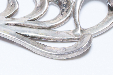 A varied collection of jewelry, including silver brooches and an 18 carat gold ring, 20th C.