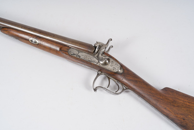 A French double barrel percussion shotgun with damask barrels and engraved breechblocks, marked 'Vrai Tordu Rubans', 19th C.