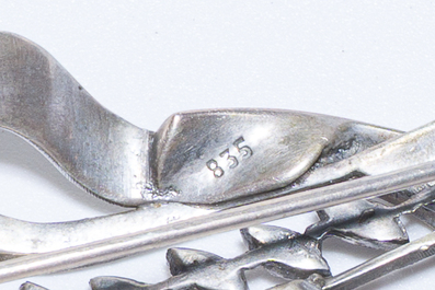 A varied collection of jewelry, including silver brooches and an 18 carat gold ring, 20th C.