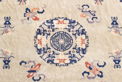 A Chinese Beijing rug with antiquities, floral design and stylized motifs, wool on cotton, 20th C.