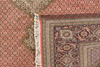 A Persian Tabriz rug with central medallion and floral design, wool on cotton, first half 20th C.