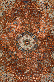 A Persian Qom (Qum/Ghom) silk rug and a Chinese silk Hereke style rug with floral design, 20th C.