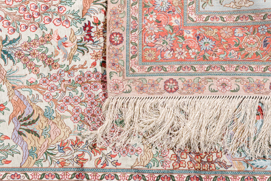 A Chinese silk Hereke style rug with birds in a landscape, 20th C.