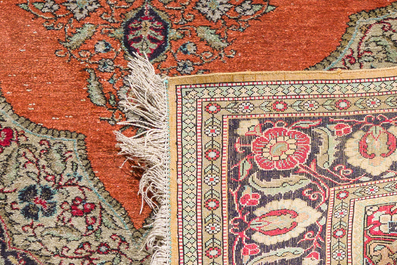 A Persian Qom (Qum/Ghom) silk rug with floral design and a Tabriz rug with animals, 20th C.