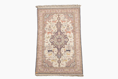 A Persian Qom (Qum/Ghom) silk rug with animals and floral design, 20th C.