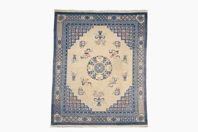 A Chinese Beijing rug with antiquities, floral design and stylized motifs, wool on cotton, 20th C.